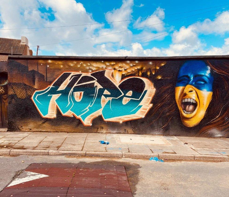 Port Talbot street art of blue and yellow face