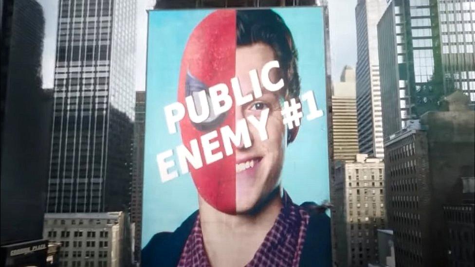 Peter Parker Spider-Man bill board reading public enemy number one.