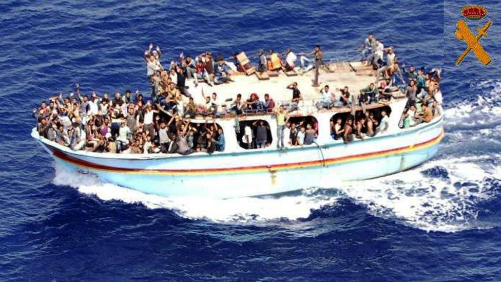 A small boat with around 300 migrants on board spotted by the Spanish Civil Guard south of Sicily, Italy - 8 September 2015