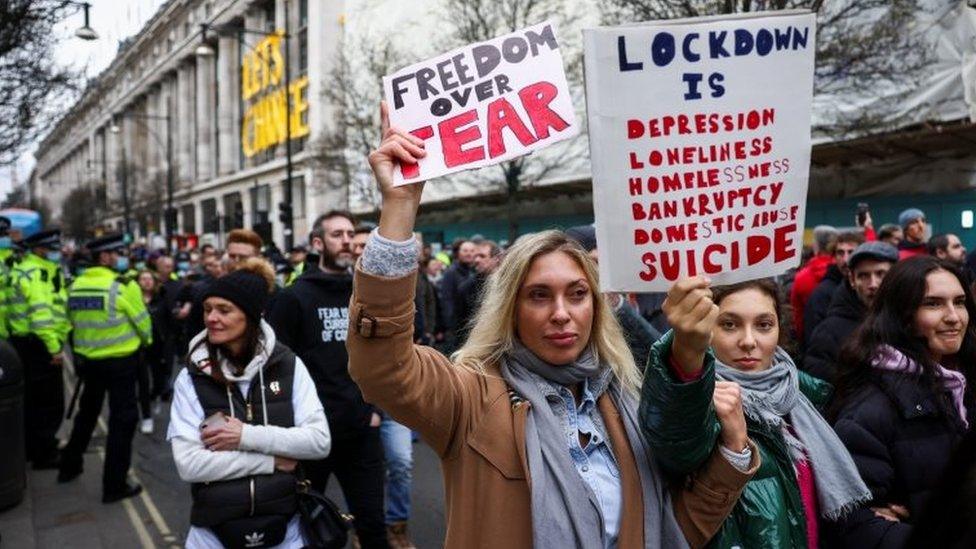 Protesters hold placards in central London