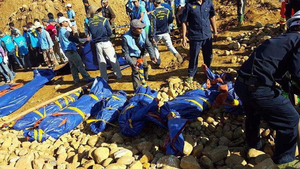 The bodies of miners killed by a landslide are placed on the ground in a jade mining area in Hpakhant, in Myanmar's Kachin state on 22November 2015