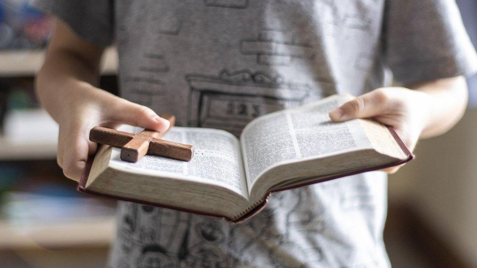 Boy reading a Bible