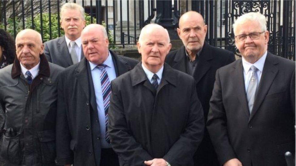 Photograph of the so-called 'hooded men' outside court'