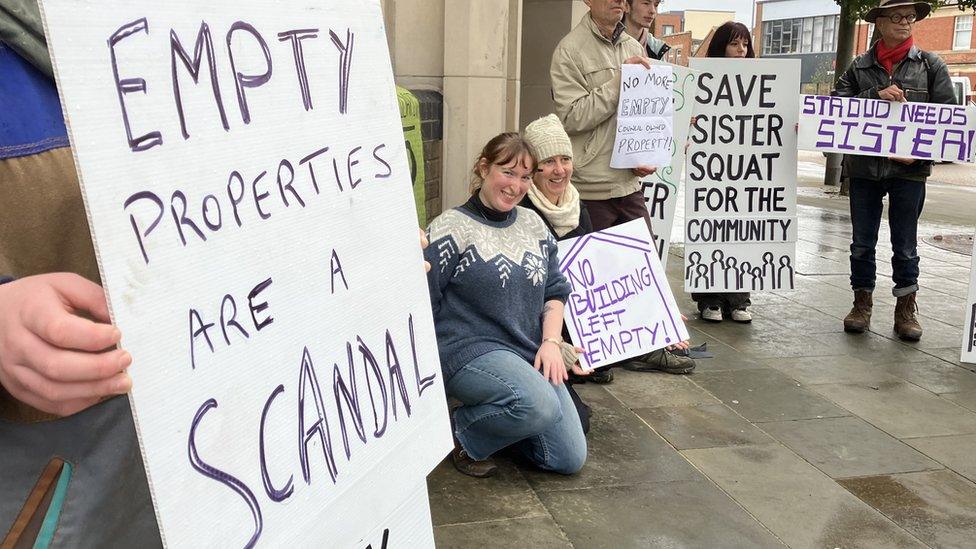 Protestors with placards saying 'empty properties are a scandal.'