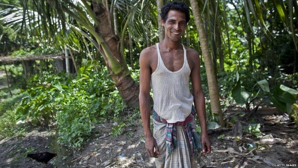 Anwarul Islam, stands for a photo after choosing Bangladeshi citizenship with the Enclaves Exchange Coordination Committee July 9, 2015 in Lalmonirhat District, Bangladesh.