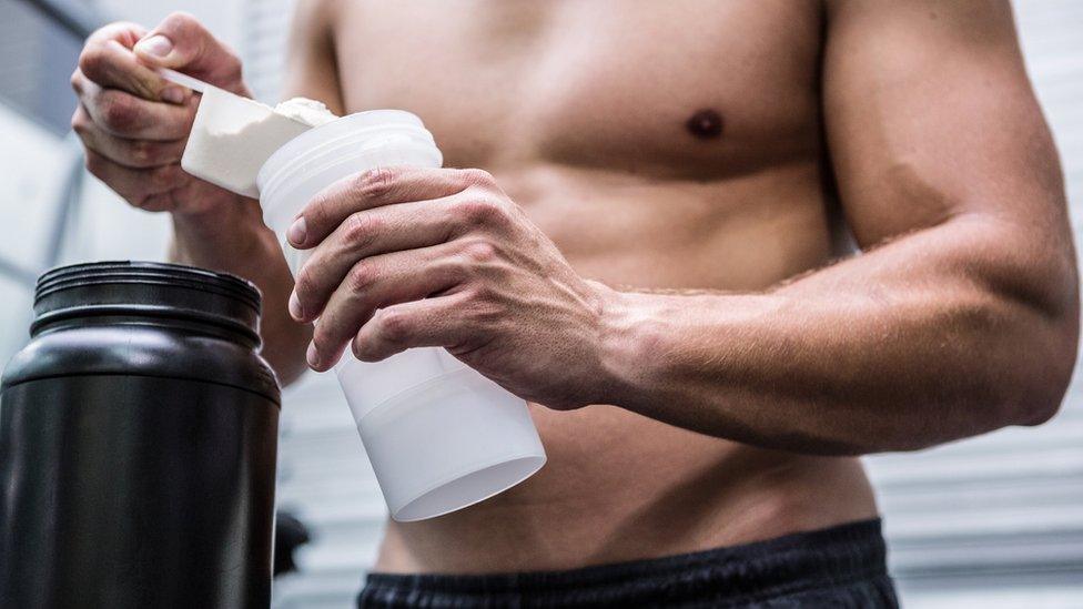 man adding powder to water