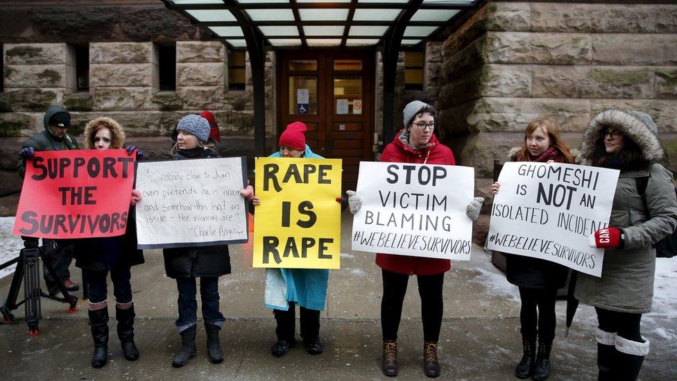 Protesters stand outside of the courthouse before an Ontario judge found former Canadian radio host Jian Ghomeshi not guilty on four sexual assault charges and one count of choking, in Toronto, March 24, 2016