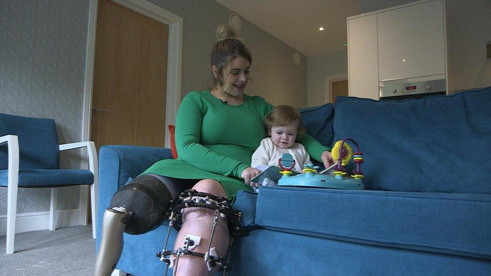 Medical gaming patient Ruby Flanagan sits on a sofa with son Leon