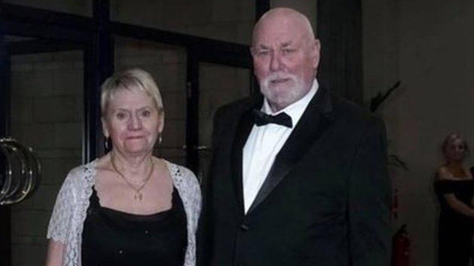 A couple dressed in black tie