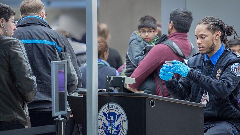 Christmas airline travelers are processed at a Transportation Safety Agency (TSA) security checkpoint December 23, 2014 at Dulles International Airport (IAD) in Sterling, Virginia, o