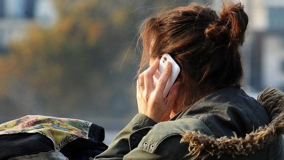 Girl with back to camera on the phone
