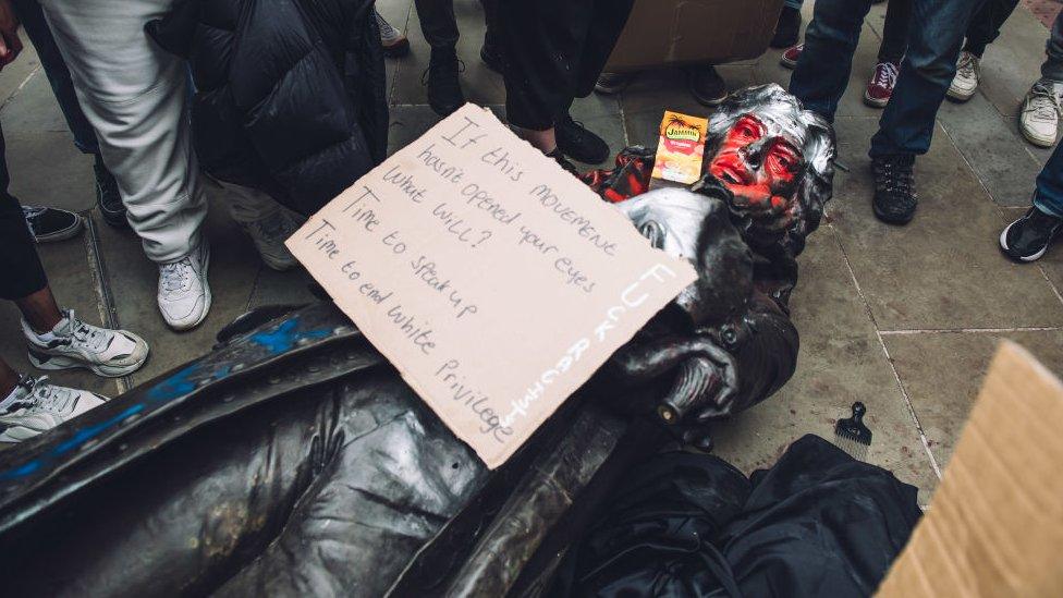 A statue of Edward Colston taken down by protestors