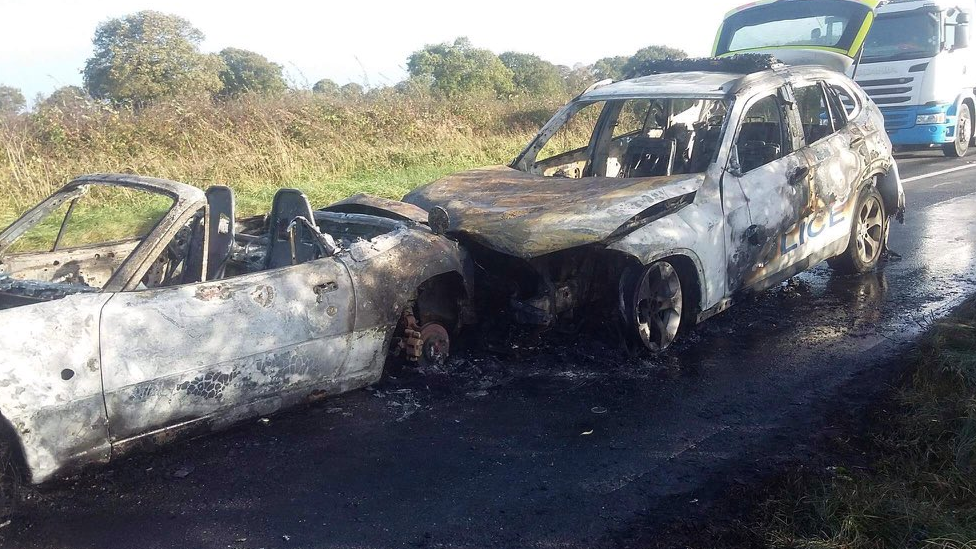 Burnt out cars after crash