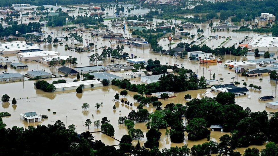 This aerial image shows flooded areas in Denhamp Springs, La., Saturday, Aug. 13, 2016