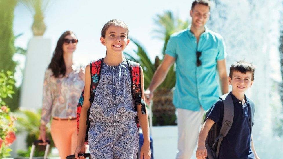 Family with luggage at holiday resort