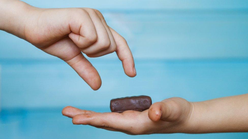 hands-showing-small-chocolate