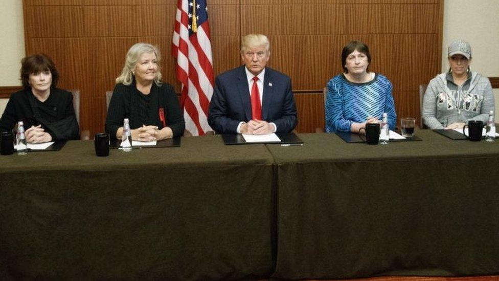 Republican presidential candidate Donald Trump, center, sits with, from right, Paula Jones, Kathy Shelton, Juanita Broaddrick, and Kathleen Willey in St. Louis, Missouri.