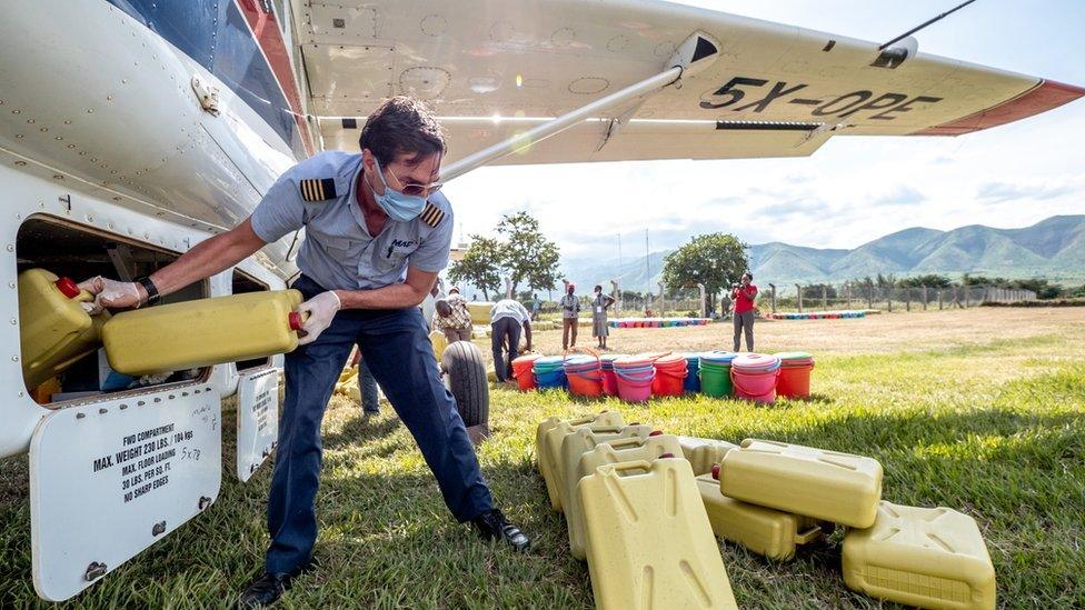 Greg unloading plane.