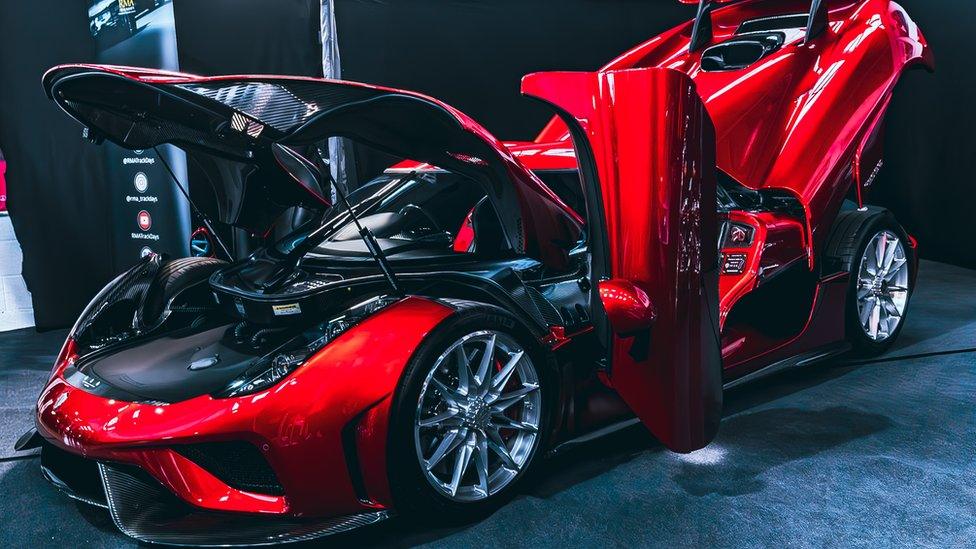 Bright red supercar with doors open