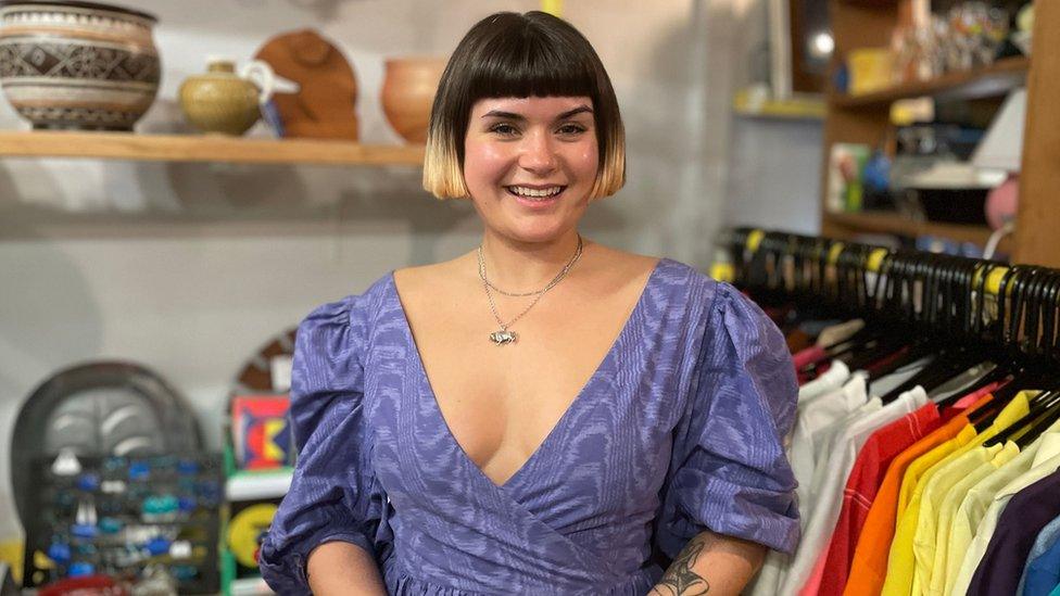 Meg Cox smiling in a purple dress