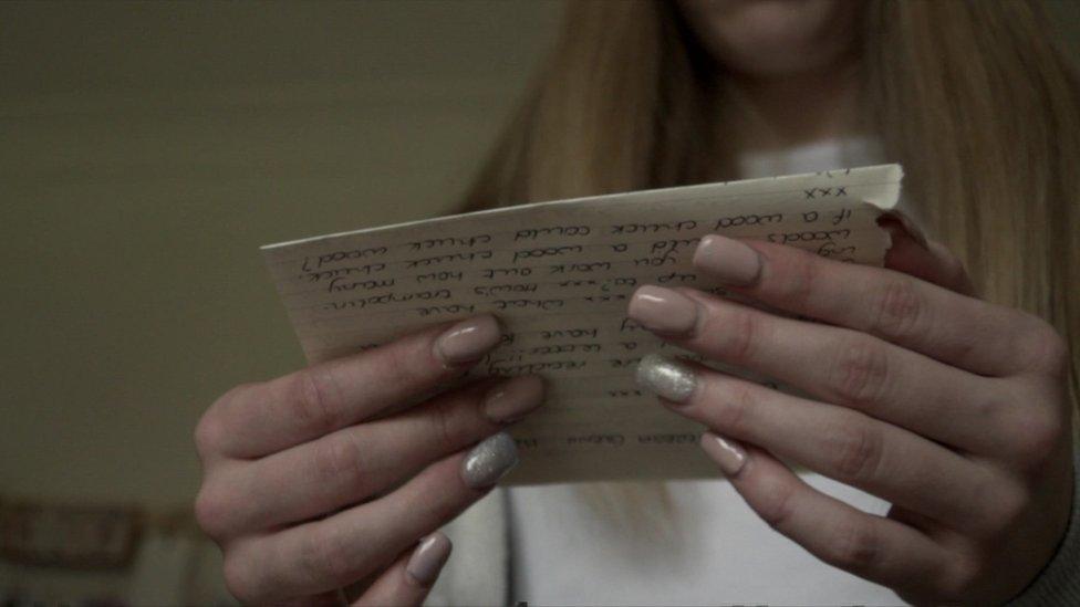 Anonymous woman whose mother was imprisoned reading a letter