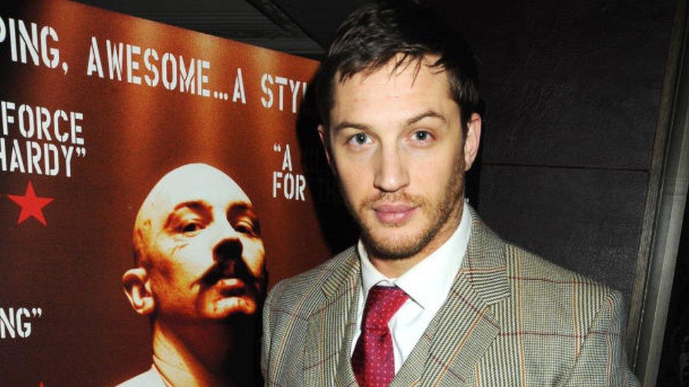 Tom Hardy with a poster for the movie Bronson