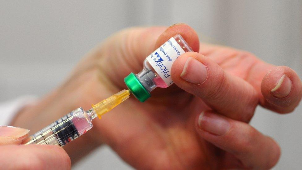 A doctor in France prepares to administer the MMR (measles mumps and rubella) combined vaccine