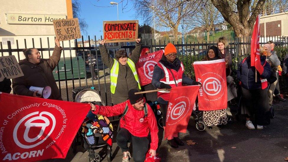 Barton House residents and Acorn community activists outside Barton House with flags and protest signs