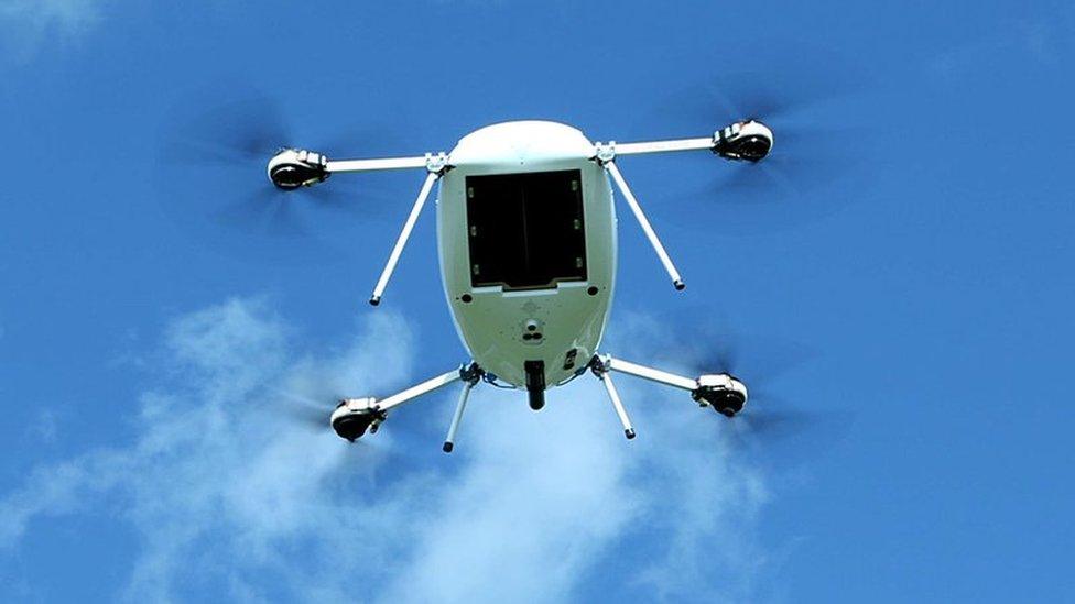 A Manna aero drone takes flight against a blue sky with scattered clouds