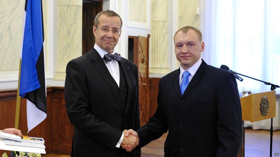 Estonian security service officer Eston Kohver, right, receives decoration from the Estonian President Toomas Hendrik Ilves, left, in February 2010