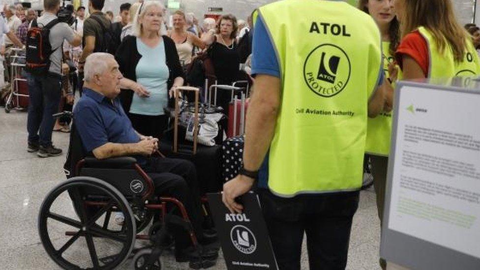 British Government officials and Atol representatives help Thomas Cook passengers at Palma the Mallorca airport