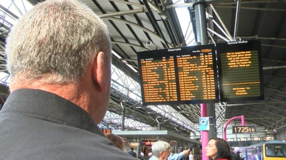 Mr Frank looking at a train information board