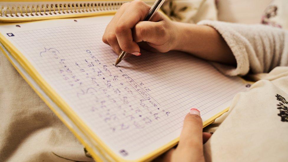 girl-writing-maths-equations.