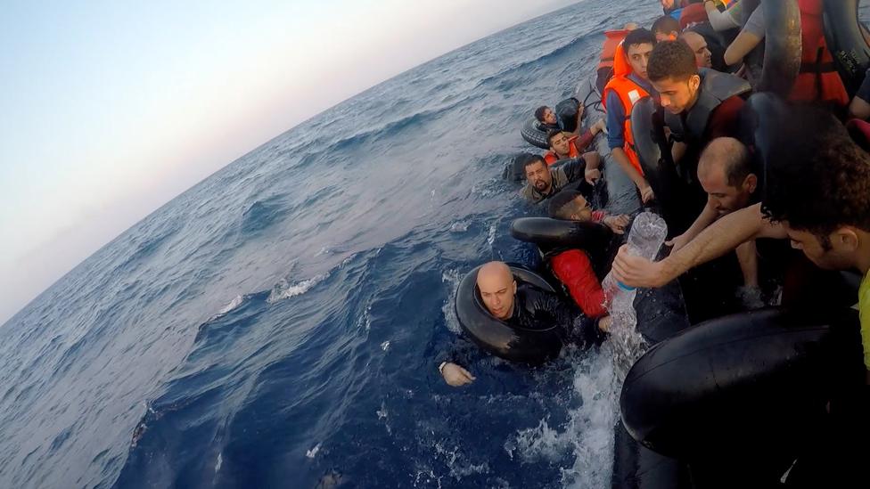 People on a sinking boat in the Mediterranean