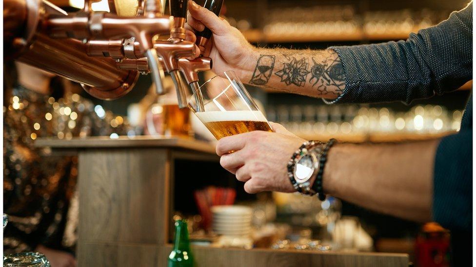 A bartender pouring beer