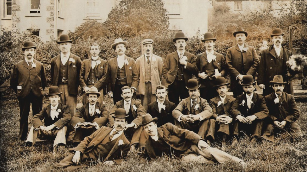 An old black and white picture of men all in hats and suits