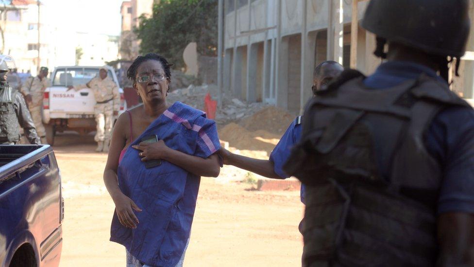 Malian security forces escort a hostage freed from the Radisson Blu hotel in Bamako