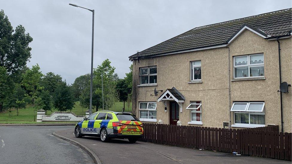 Police car parked outside scene of fire