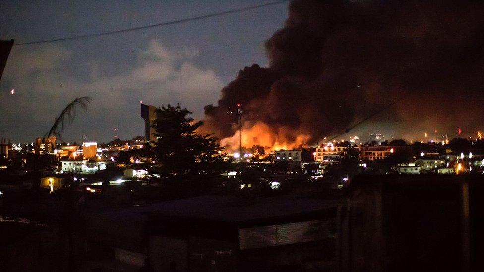 Smoke and flames billow from the National Assembly building in Libreville after it was set ablaze on August 31, 2016