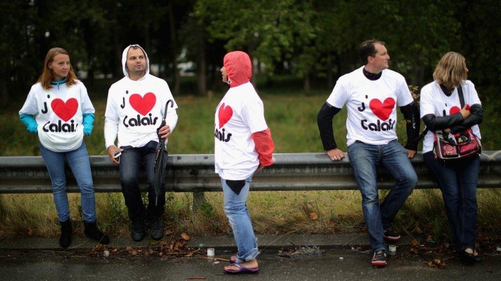 People in 'I love Calais' t-shirts