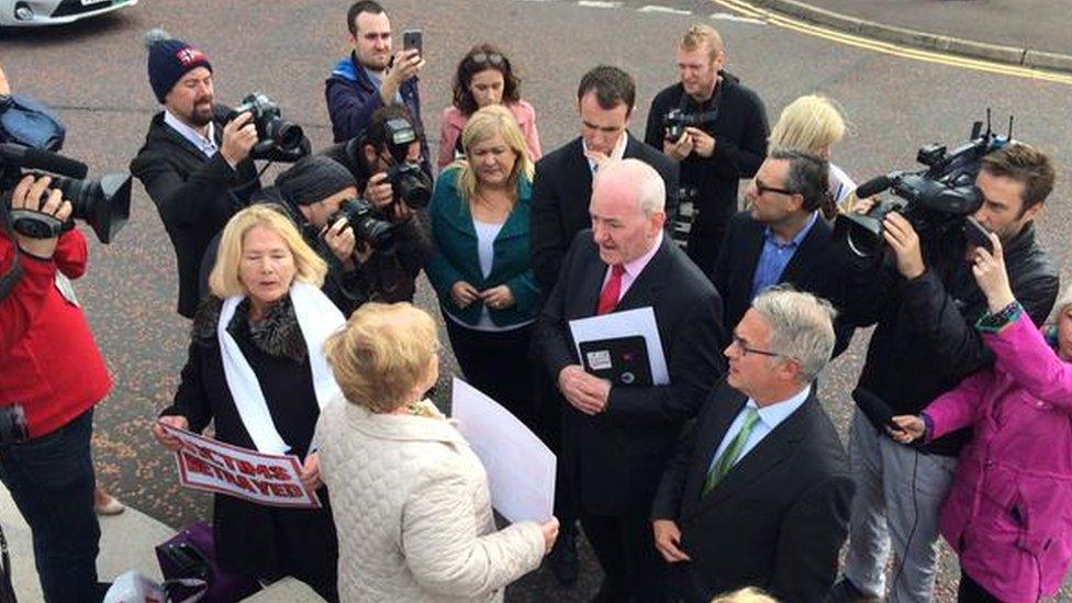 Women whose relatives died in the Troubles confront the SDLP outside the talks