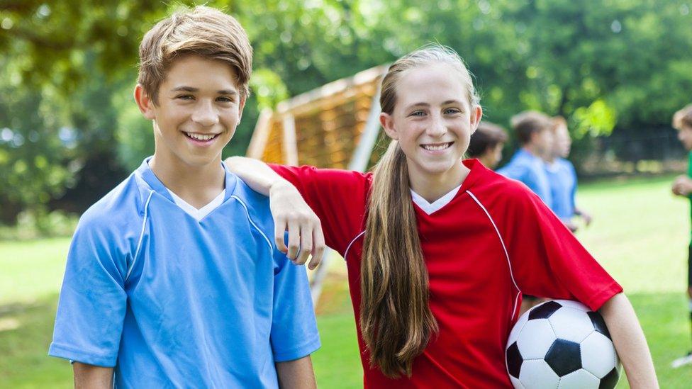 boy and girl playing football