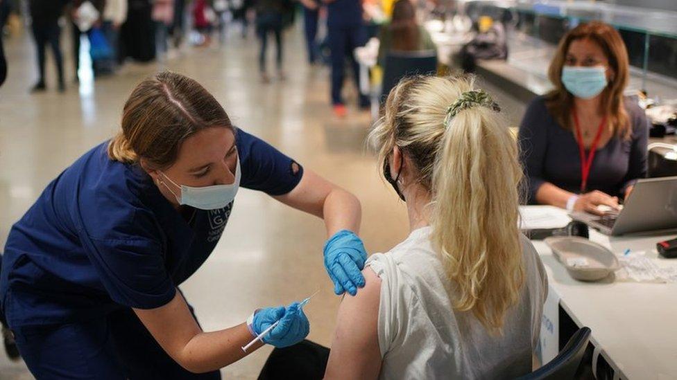 Rosi Stamp, aged 25, receives a Pfizer BioNTech COVID-19 vaccine at an NHS Vaccination Clinic at Tottenham Hotspur"s stadium in north London