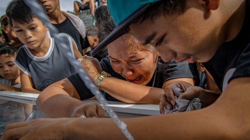 Relatives weep during the funeral of 23-year-old Jaybee Castor on July 18, 2019 in Manila, Philippines.