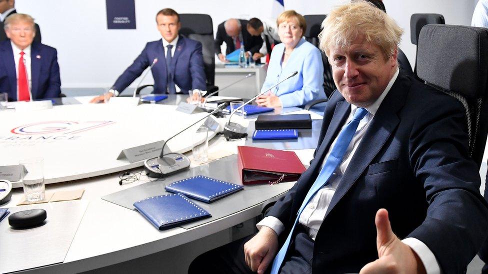 Donald Trump, Emmanuel Macron, Angela Merkel and Boris Johnson at the G7 summit, France 2019