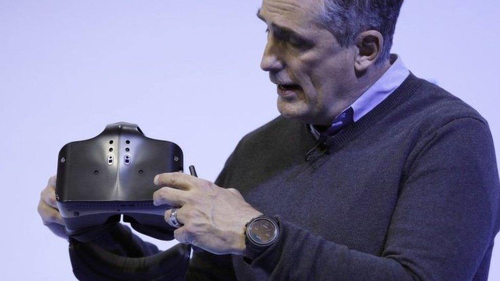 Brian Krzanich holds a Project Alloy headset