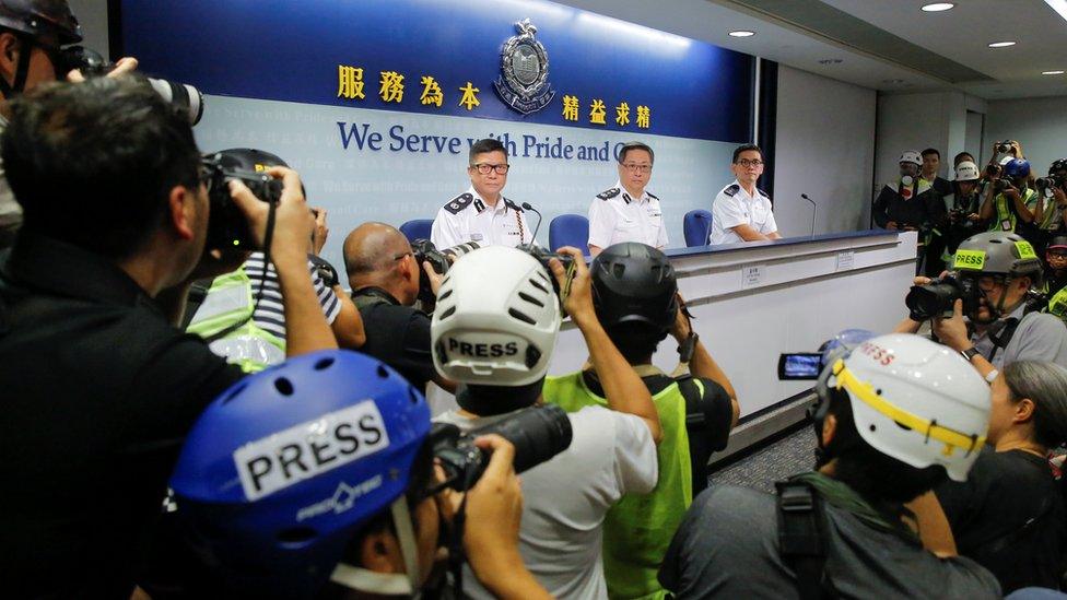 Press photographers wear helmets and protective masks to denounce police treatment during yesterday"s protest against a proposed extradition bill with China in Hong Kong, China, June 13, 2019