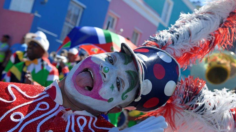 A-dancer-dressed-as-a-clown-sticks-out-his-tongue.