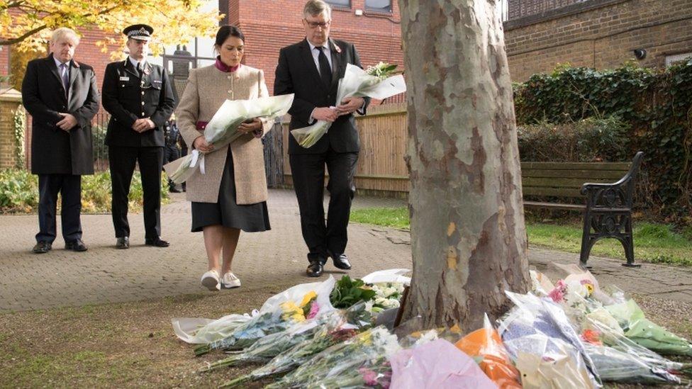 Priti Patel and Boris Johnson laying flowers