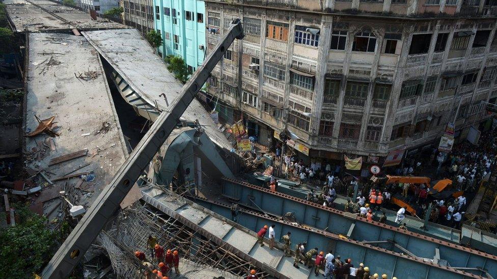 Indian rescue workers try to free people trapped under the wreckage of a collapsed flyover bridge in Kolkata on April 1, 2016.